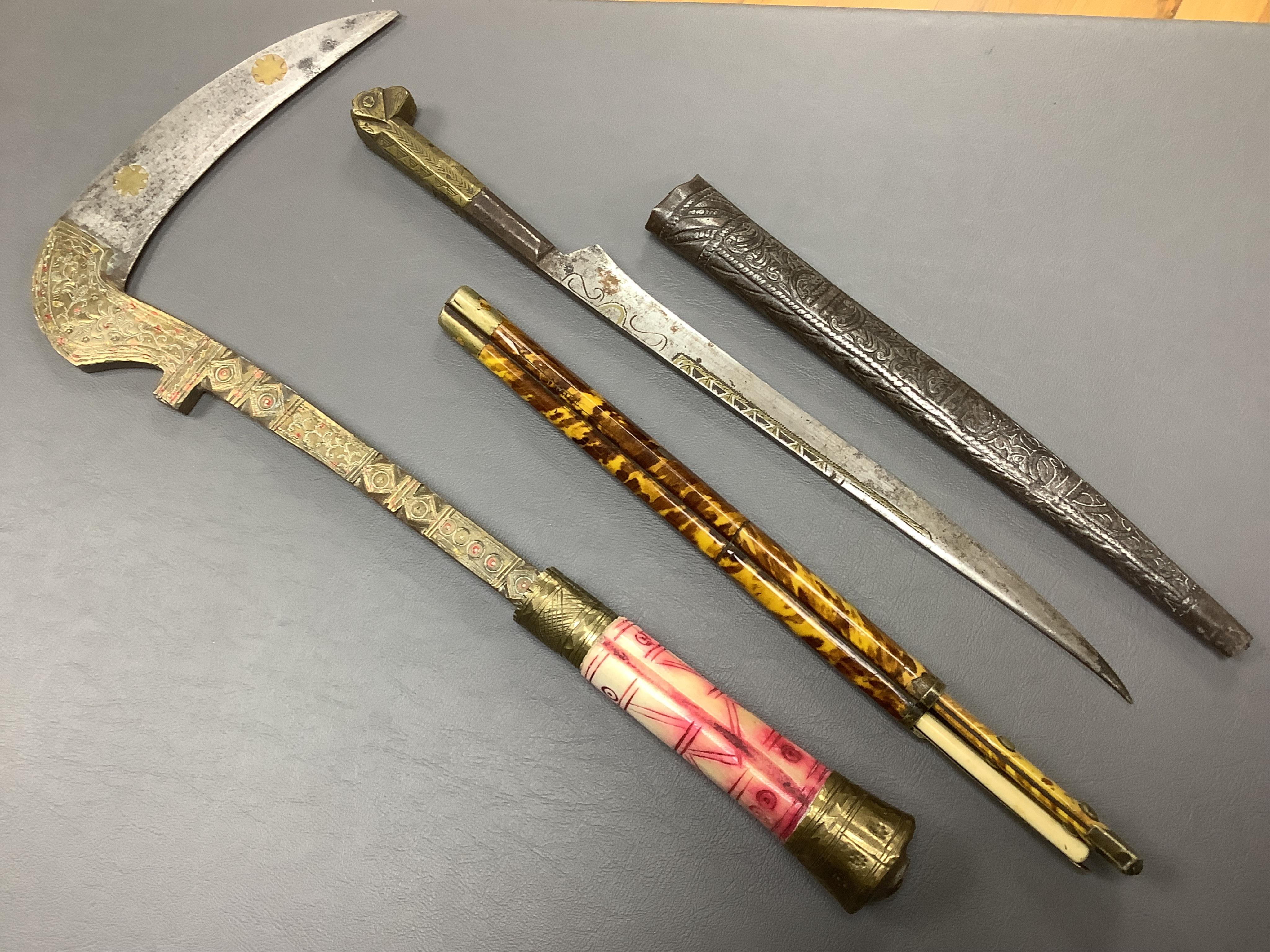 Eighteen assorted world weapons comprising a silver jambya (pommel missing), a knobkerry, a dha, two kris (one with handle missing), a lohar, three kukris, a djambok, a Chinese trousse, a chora, a flyssa, five others and